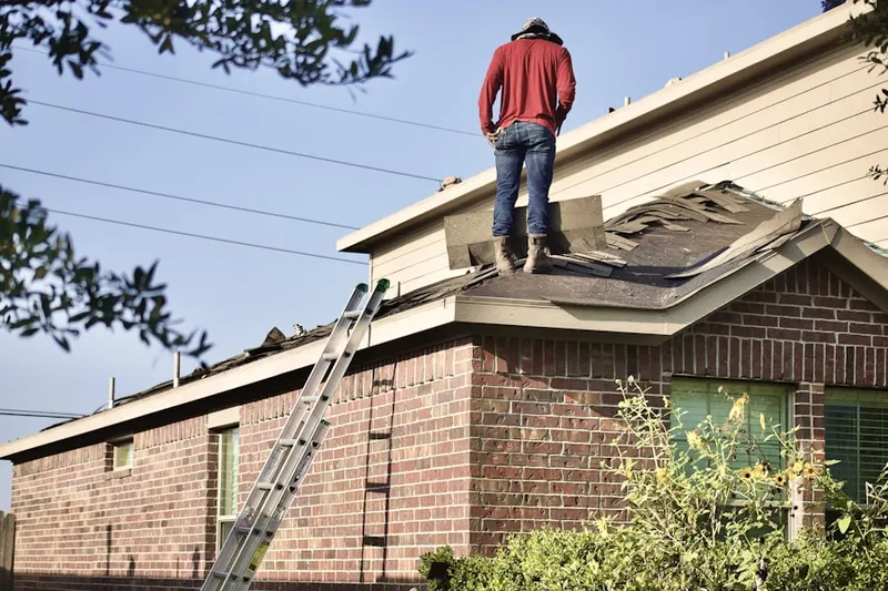 Professional roofer working on a residential roof in Hutchins
